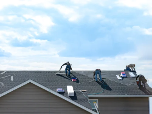 roofers fixing a shingle roof